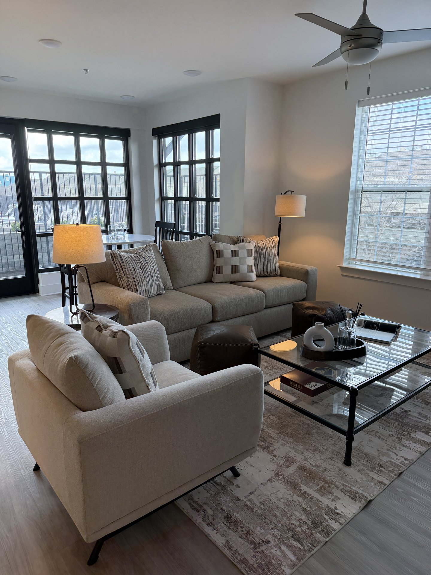 Living room with beige sofas and glass coffee table